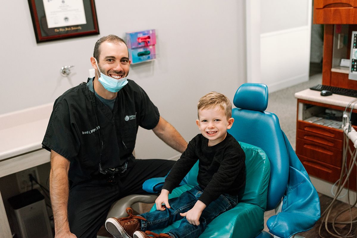 smiling dentist and child patient